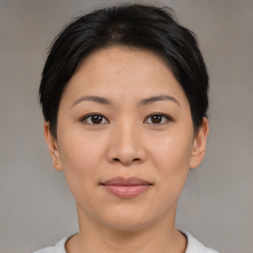 Joyful asian young-adult female with short  black hair and brown eyes