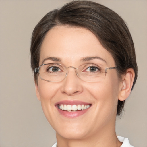 Joyful white adult female with medium  brown hair and brown eyes