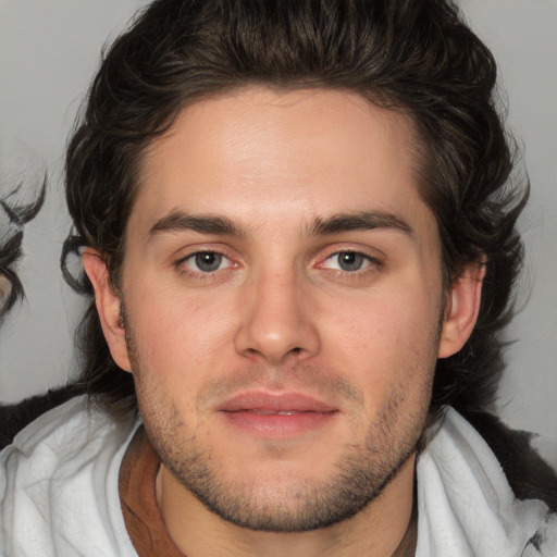 Joyful white young-adult male with medium  brown hair and brown eyes