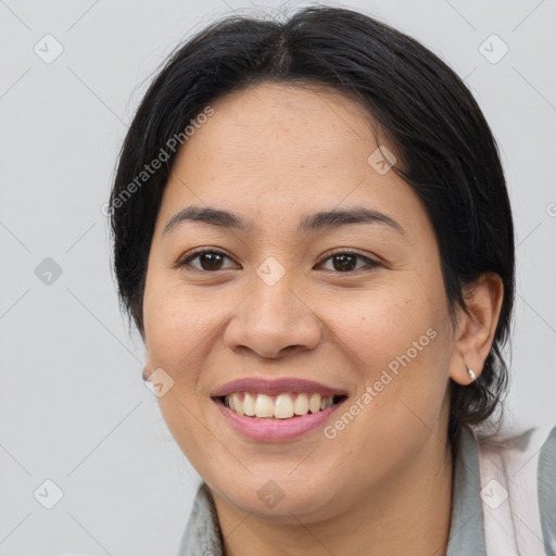 Joyful asian young-adult female with medium  brown hair and brown eyes