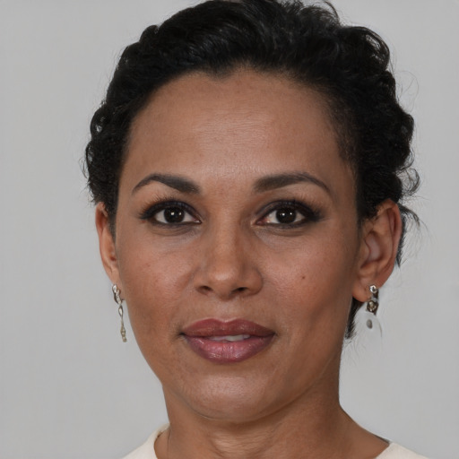 Joyful black adult female with short  brown hair and brown eyes