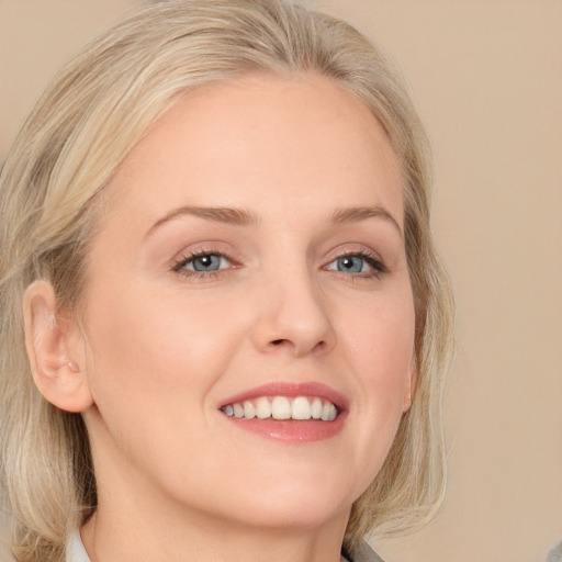 Joyful white young-adult female with medium  blond hair and blue eyes