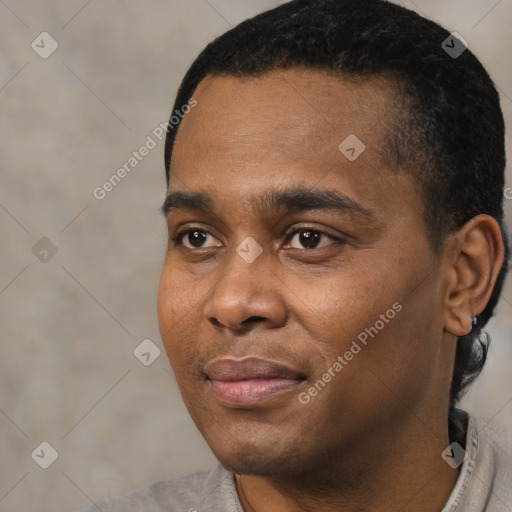 Joyful black young-adult male with short  black hair and brown eyes