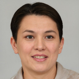 Joyful white adult female with short  brown hair and brown eyes