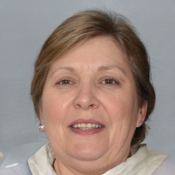 Joyful white adult female with medium  brown hair and blue eyes