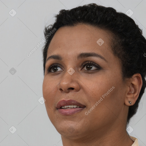 Joyful black young-adult female with short  black hair and brown eyes