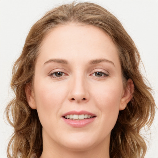 Joyful white young-adult female with long  brown hair and blue eyes