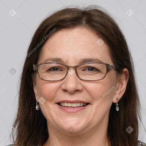 Joyful white adult female with long  brown hair and grey eyes