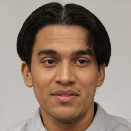 Joyful latino young-adult male with short  brown hair and brown eyes