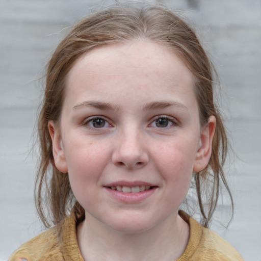 Joyful white child female with medium  brown hair and grey eyes