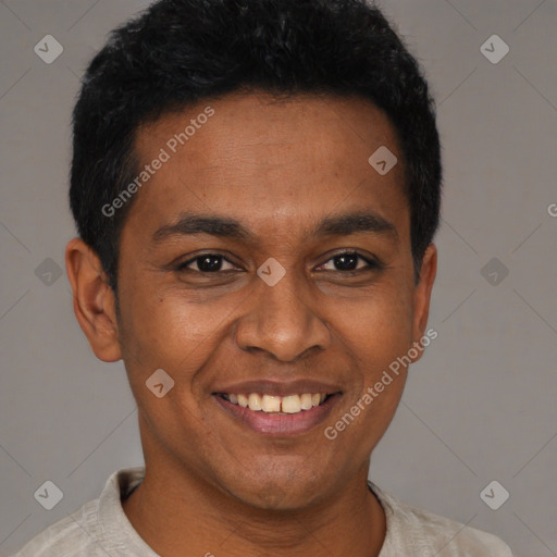 Joyful latino young-adult male with short  black hair and brown eyes