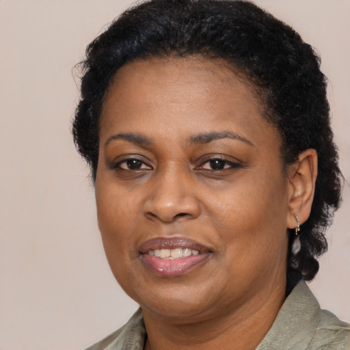 Joyful black adult female with short  brown hair and brown eyes