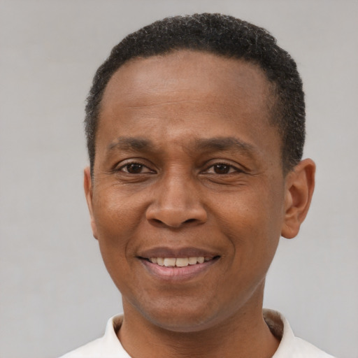 Joyful black adult male with short  black hair and brown eyes
