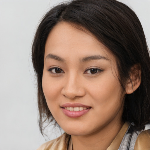 Joyful asian young-adult female with long  brown hair and brown eyes
