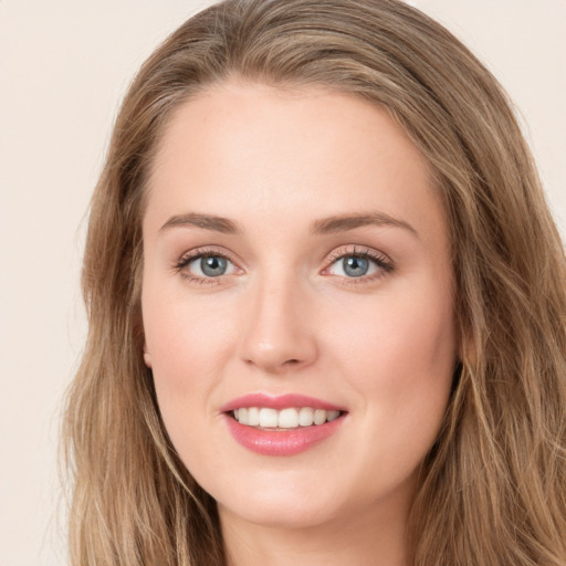 Joyful white young-adult female with long  brown hair and green eyes