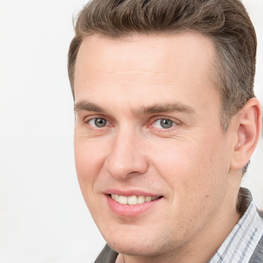 Joyful white adult male with short  brown hair and brown eyes