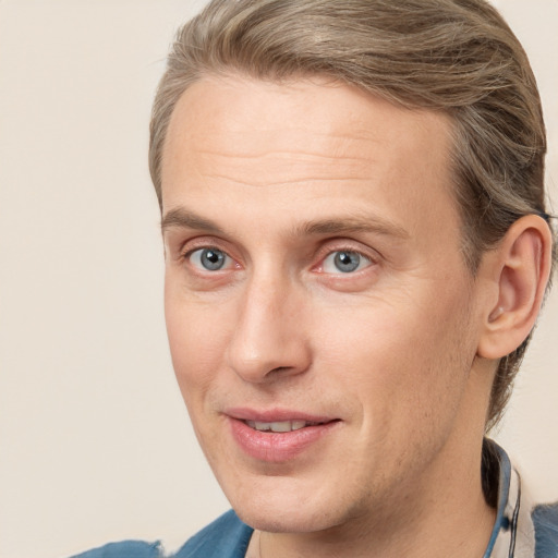 Joyful white adult male with medium  brown hair and brown eyes