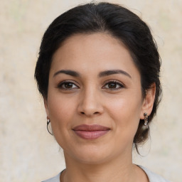 Joyful latino young-adult female with medium  brown hair and brown eyes