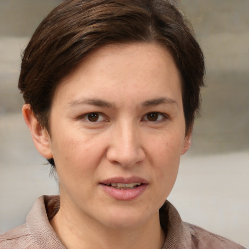 Joyful white adult female with short  brown hair and brown eyes