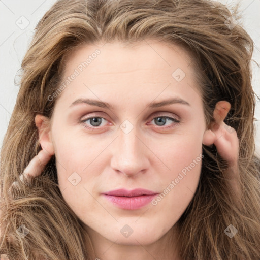 Joyful white young-adult female with long  brown hair and blue eyes