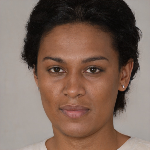 Joyful black young-adult female with short  brown hair and brown eyes