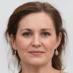 Joyful white adult female with medium  brown hair and grey eyes