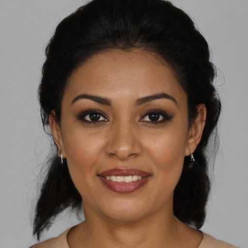 Joyful latino young-adult female with medium  brown hair and brown eyes