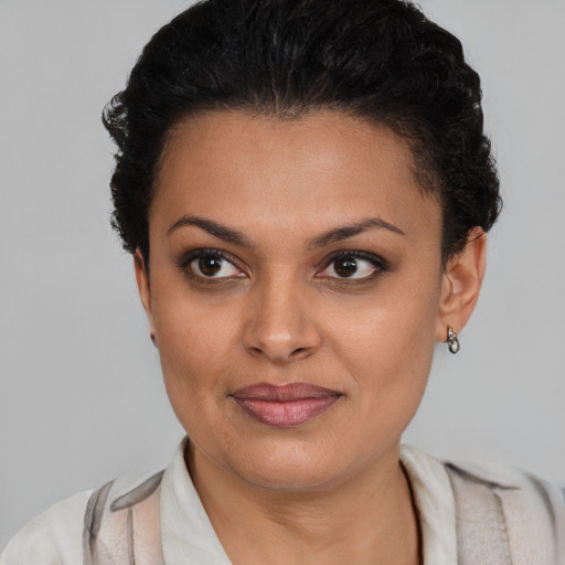 Joyful latino young-adult female with short  brown hair and brown eyes