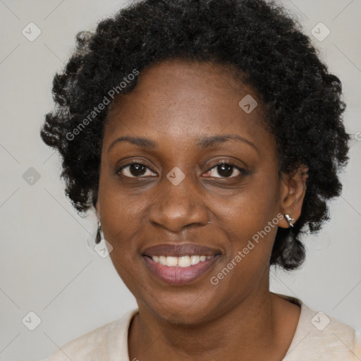 Joyful black adult female with short  brown hair and brown eyes