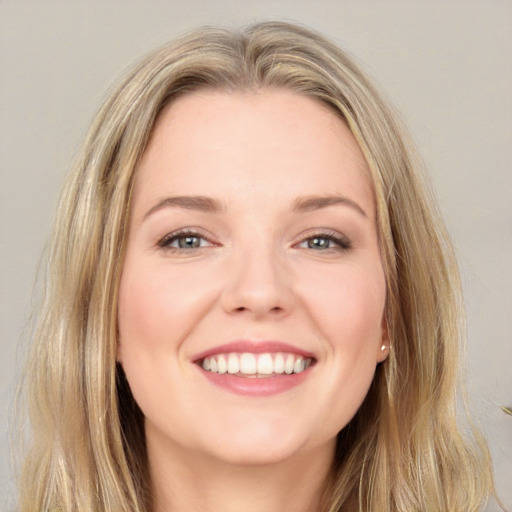 Joyful white young-adult female with long  brown hair and blue eyes