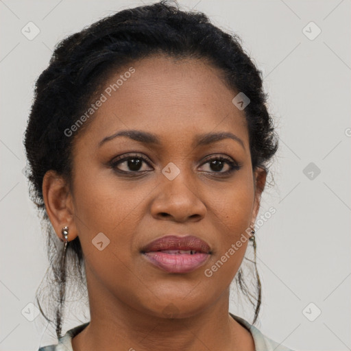 Joyful black adult female with long  brown hair and brown eyes