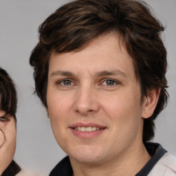 Joyful white young-adult male with medium  brown hair and brown eyes