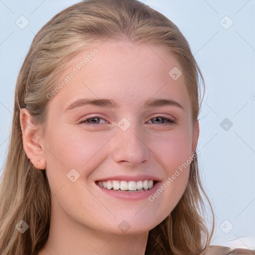 Joyful white young-adult female with long  brown hair and blue eyes