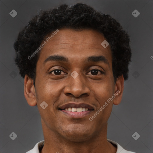 Joyful black young-adult male with short  brown hair and brown eyes