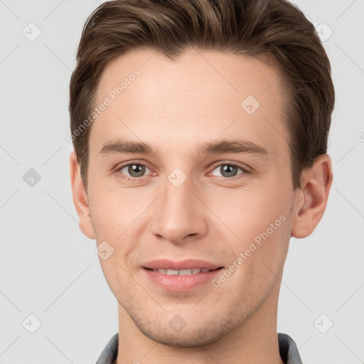 Joyful white young-adult male with short  brown hair and grey eyes