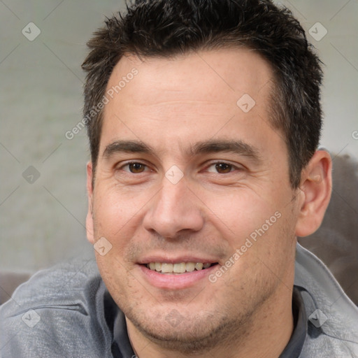 Joyful white adult male with short  brown hair and brown eyes