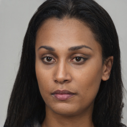Neutral latino young-adult female with long  brown hair and brown eyes