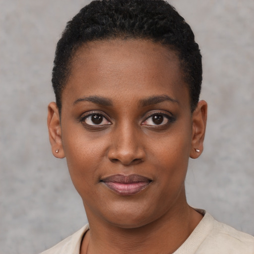 Joyful black young-adult female with short  brown hair and brown eyes