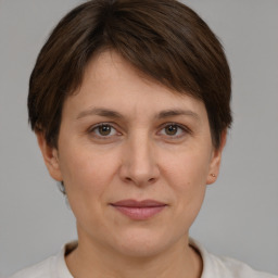 Joyful white adult female with short  brown hair and brown eyes