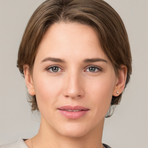 Joyful white young-adult female with medium  brown hair and grey eyes