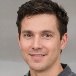 Joyful white adult male with short  brown hair and grey eyes