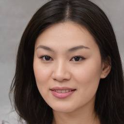 Joyful asian young-adult female with long  brown hair and brown eyes