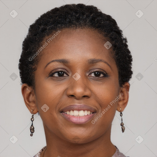 Joyful black young-adult female with short  brown hair and brown eyes