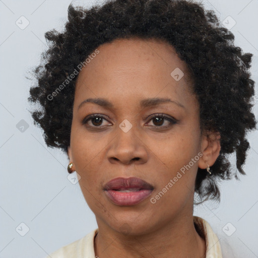 Joyful black adult female with short  brown hair and brown eyes