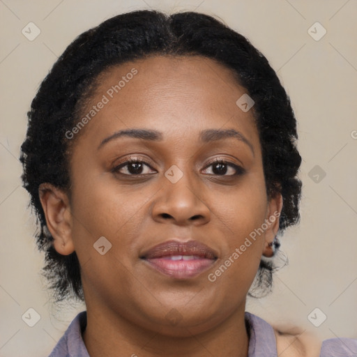 Joyful black adult female with medium  brown hair and brown eyes