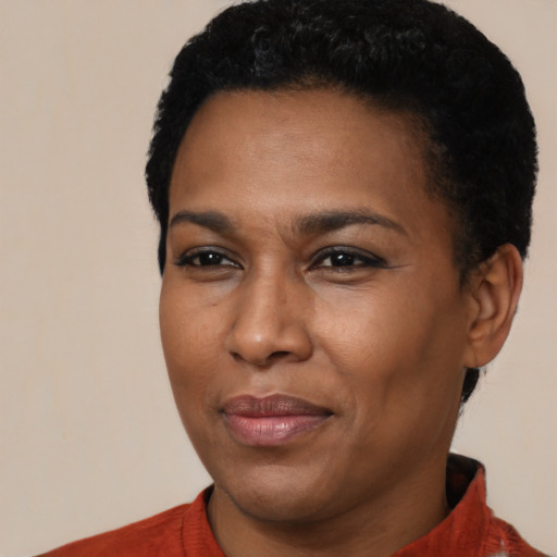 Joyful black young-adult female with short  black hair and brown eyes