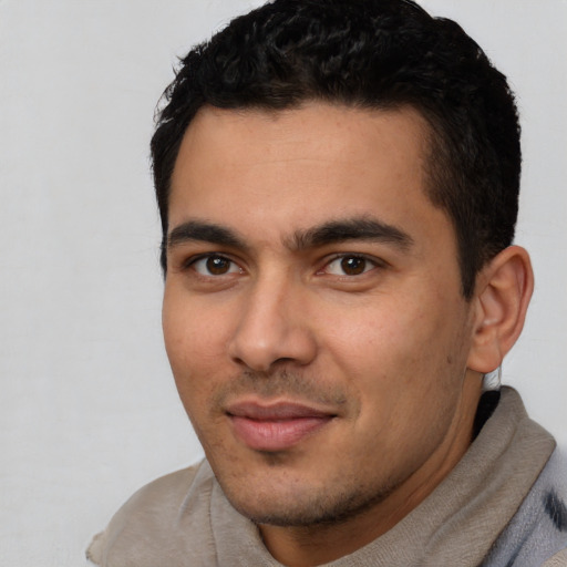 Joyful latino young-adult male with short  black hair and brown eyes