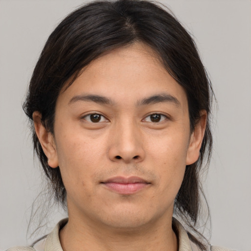 Joyful asian young-adult male with medium  brown hair and brown eyes
