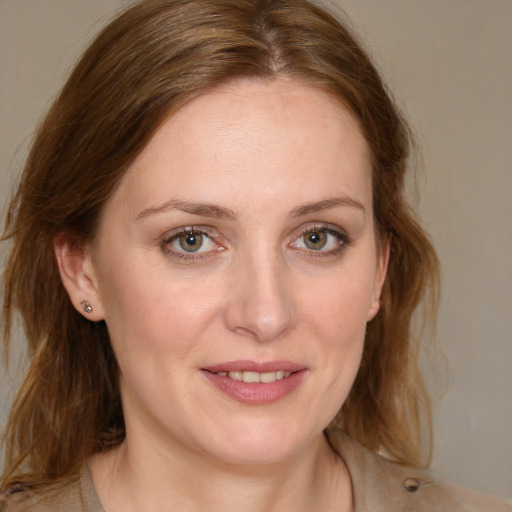 Joyful white young-adult female with long  brown hair and blue eyes