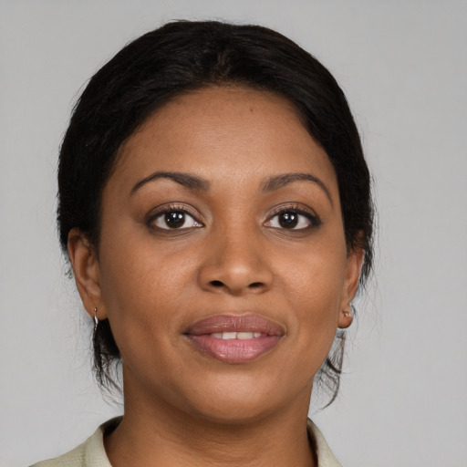 Joyful black young-adult female with medium  brown hair and brown eyes